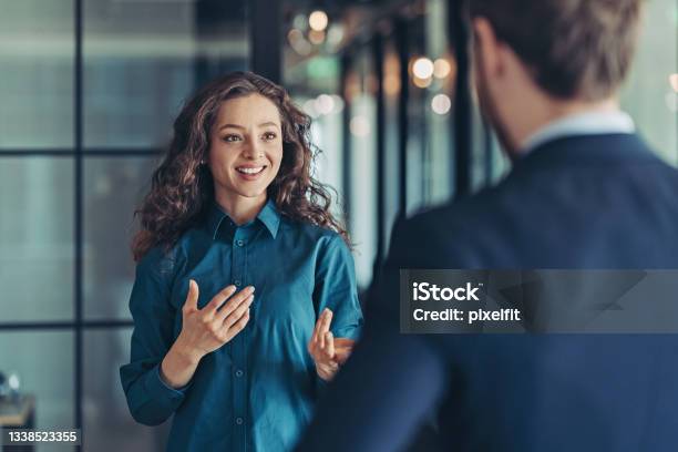 Businesswoman Talking To A Colleague Stock Photo - Download Image Now - Discussion, Talking, Advice