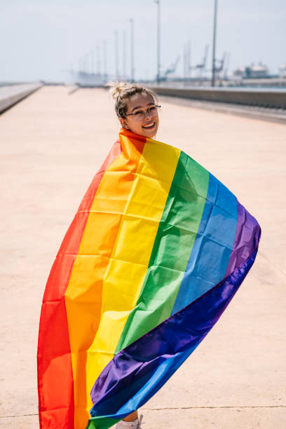 istock Young woman waving lgbti flag 1338523937