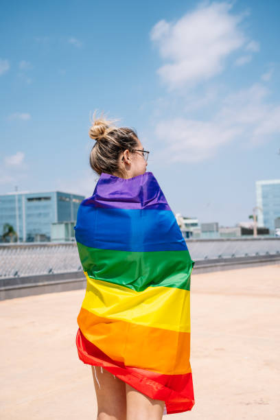 istock Young woman waving lgbti flag 1338523979