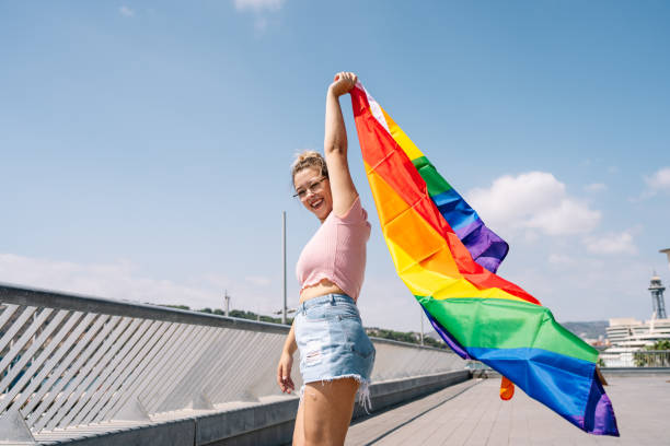 istock Young woman waving lgbti flag 1338524003