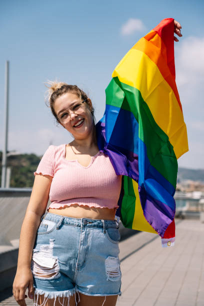 istock Young woman waving lgbti flag 1338524454