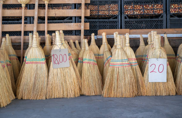 Traditional short hand brooms for sale with price tag in bazaar