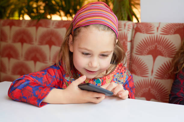 istock girl with a happy face watching a smartphone 1338529584