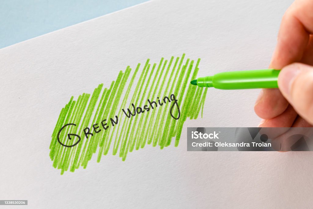 Greenwashing concept. Drawing on paper with text and green marker strokes. Environmental marketing disinformation. Non transparent green sheen. Greenwashing concept. Drawing on paper with text and green marker strokes. Environmental marketing disinformation. Non transparent green sheen. High quality photo Environment Stock Photo