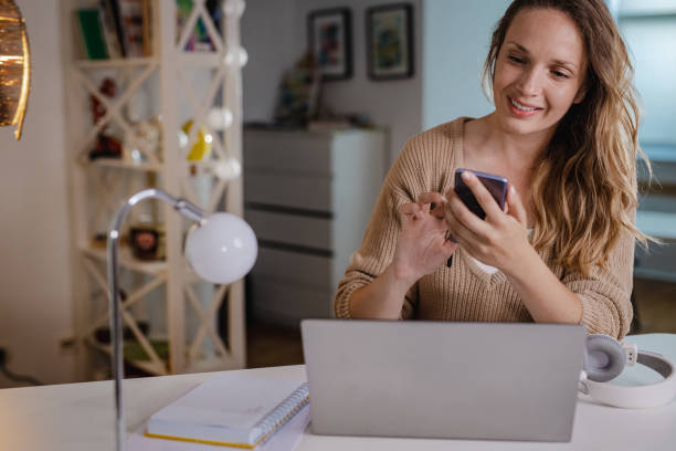 istock Working at home on laptop and using mobile phone 1338532493