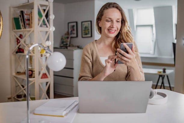 istock Working at home on laptop and using mobile phone 1338532669