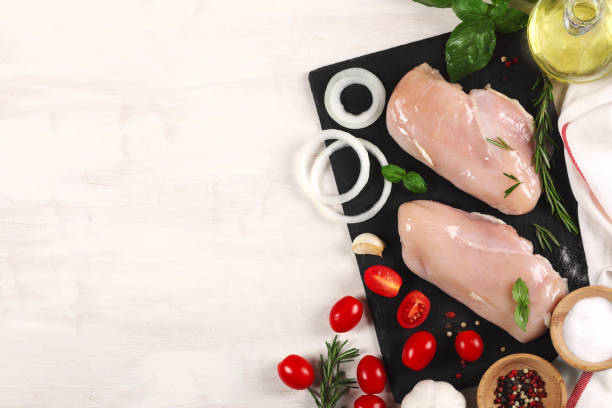 istock Raw chicken fillet with herbs and spices, top view, copy space 1338532827