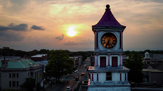 Hopkinsville, KY, USA - July 17, 2021: The clock tower in the center of historic downtown Hopkinsville, Kentucky at sunset.