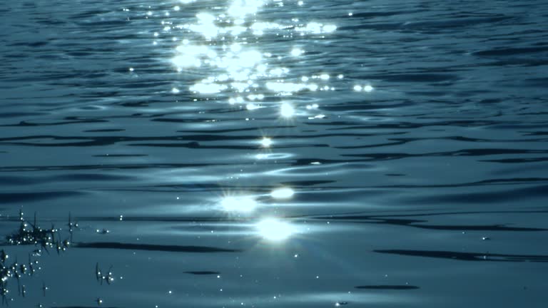 The night sea reflects the bright moonlight, close-up