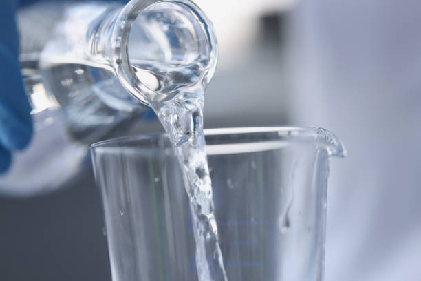 istock Water is poured from transparent bottle into glass 1338538775