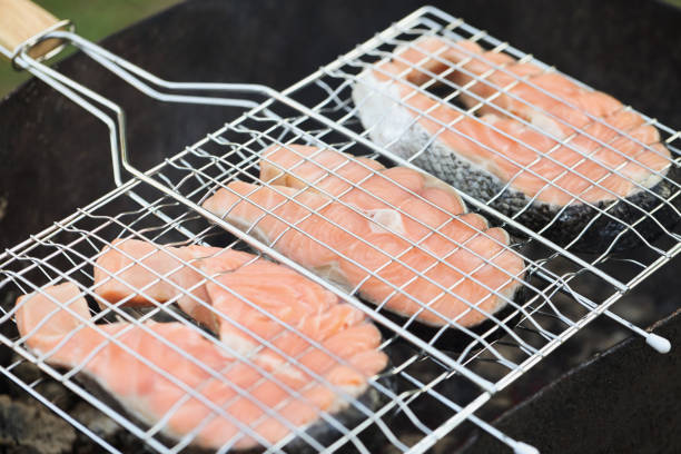 Grilled fish salmon pieces on hot grill. Cooking fish on charcoal concept
