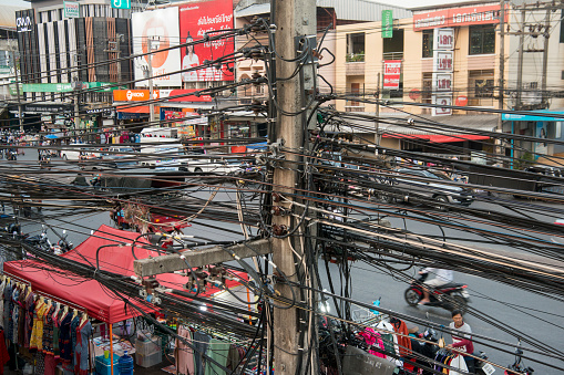 power lines at the mainroad at the Thai Border in the town of Mae Sai on the Border to Myanmar in the Chiang Rai Province in North Thailand.   Thailand, Mae Sai, November, 2019