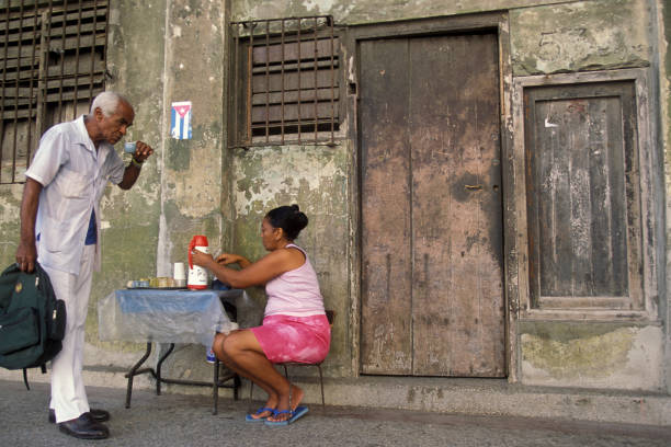 a cafe seller at a market in the city of Havana on Cuba in the caribbean sea.   Cuba, Havana, October, 2005