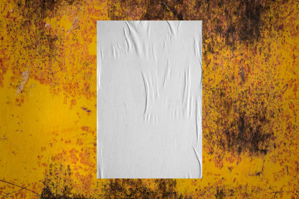 istock Blank white wheatpaste glued paper poster mockup on old metal wall background 1338552497
