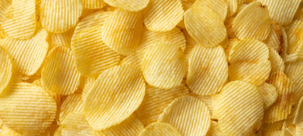 istock crispy golden potato chips snack texture background 1338552501