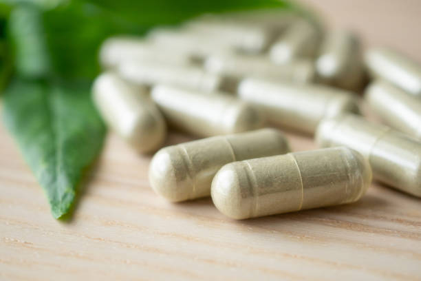 istock Herbal medicine capsules with Andrographis paniculata leaf on wood table 1338552556