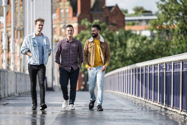 istock Men enjoying sunny weekend walk across Chelsea Bridge 1338553680