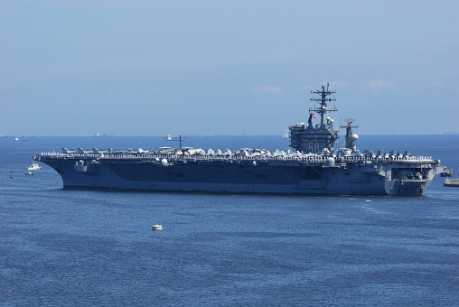 Aerial view of naval ship travelling in San Diego Bay, San Diego, California, USA.