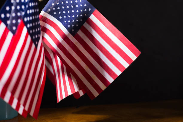 istock American flags on wooden desk top. 1338559305