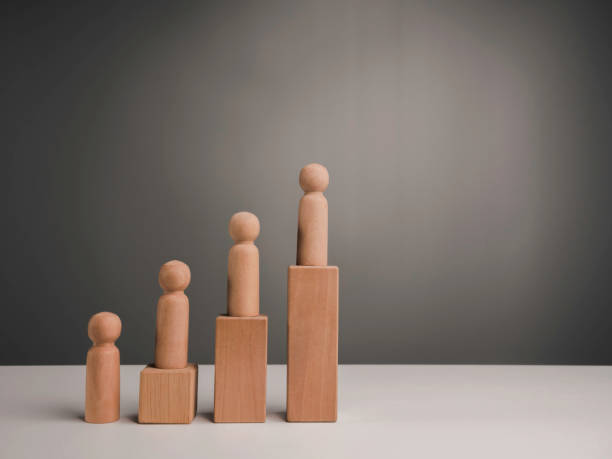 istock The miniature wooden figures standing on wood block steps. 1338567795