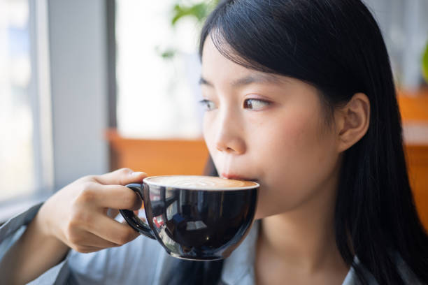 Young asian drinking cup of coffee