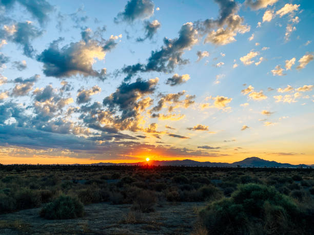 istock sunrise over desert mountain area with distant hills and clouds 1338576784