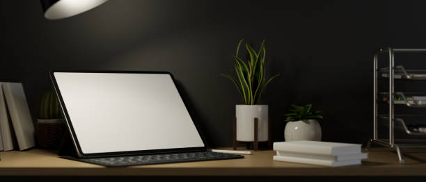 istock Modern stylish workplace with digital tablet blank screen mockup in evening, 3d rendering 1338576853