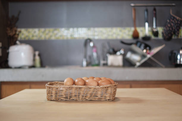 farm-fresh eggs piled up in wooden baskets in the home's kitchen. - eggs animal egg stack stacking imagens e fotografias de stock