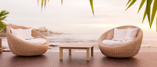 istock Two wicker chair and wood table with space for display, beach view in the background 1338585339