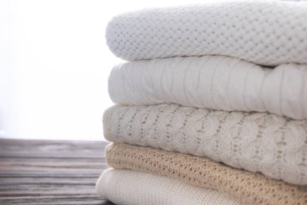 istock Warm, cozy clothes are stacked. Background from different knitted patterns. Autumn or winter concept. 1338590317
