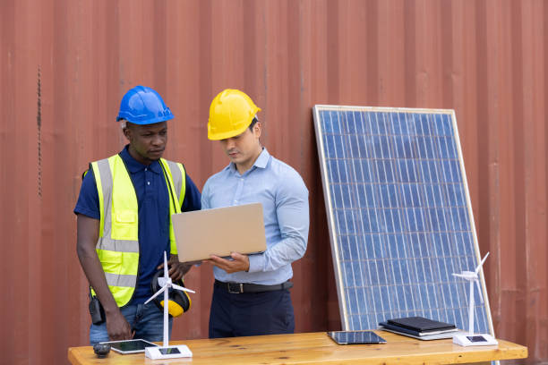 istock supervisor and engineering are discussing projects about solar energy and  wind energy systems on laptop, clean energy industry to reduce global warming concept 1338591835