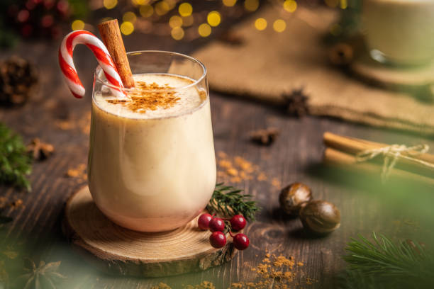 Eggnog with spicy cinnamon.Christmas and winter holidays,Cozy cocktail with cinnamon and candy cane,Traditional Christmas drink with grated nutmeg and cinnamon,Homemade Holiday drink stock photo