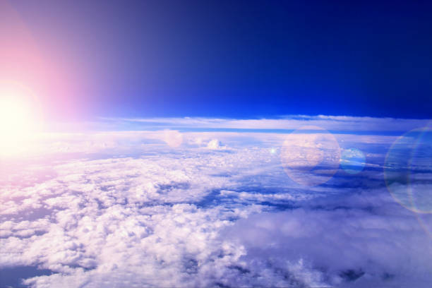 sunrise in the stratosphere above the clouds. flying above the clouds in the morning sunlight - earth stratosphere space planet imagens e fotografias de stock