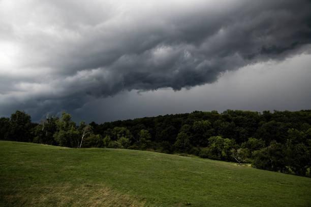 Photo of storm clouds over a hill