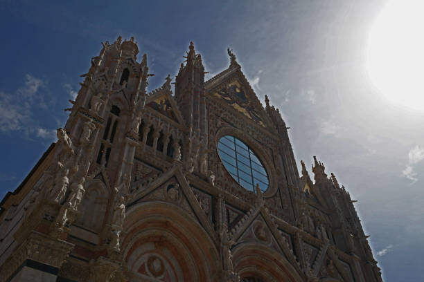 Low angle cropped Duomo di Siena church and bell tower, Siena, Italy.