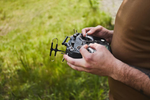 istock Man flying a high-speed racing drone with remote controller.  remote aerial quadcopter drone 1338600784
