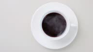 istock Cinemagraph, steaming fresh brewed hot coffee in a white cup, loop seamless motion, top view 1338601859