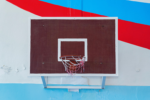 Square Basketball hoop in the gym of the Russian school. A wall with the colors of the Russian flag