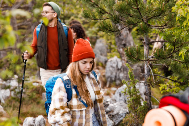 istock Young backpackers hiking through the woods. 1338606393