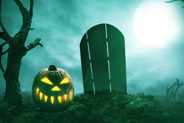 istock Scary halloween pumpkin on graveyard 1338606402