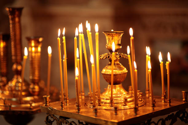 istock Many Long Burning candles during church service 1338609606