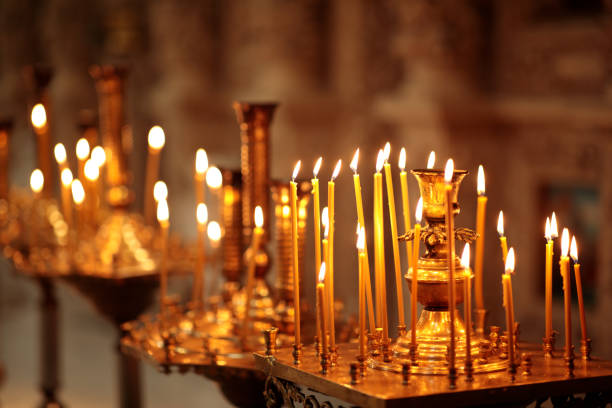 istock Many Long Burning candles during church service 1338609613