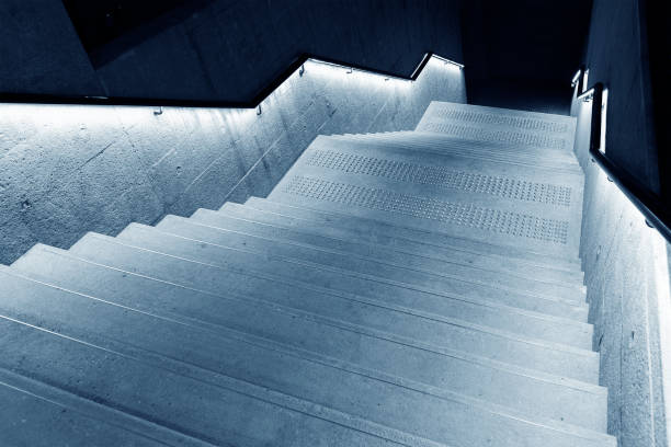 istock Interior view of empty stairway with illuminated banister in modern architecture 1338609836