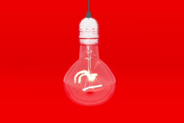 istock Incandescent lamp on red background. Electricity. 3D rendering. 1338611841
