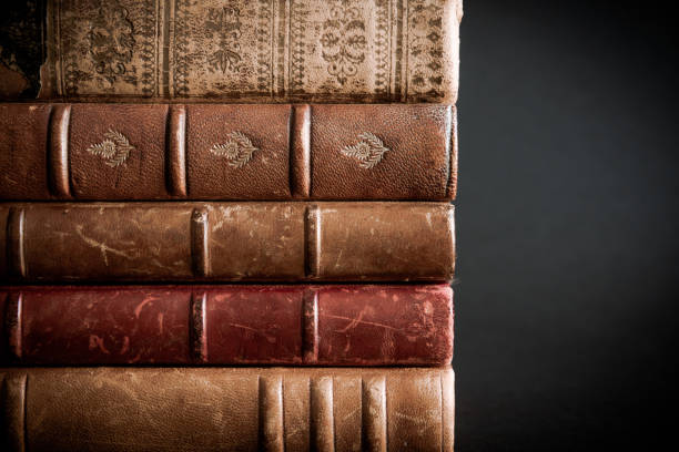istock Stack of old books on black background 1338612195