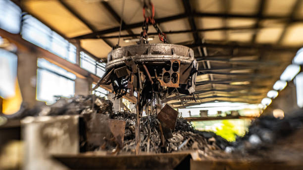 magnetic device on crane used for transport of metal scrap - magnetic storage imagens e fotografias de stock