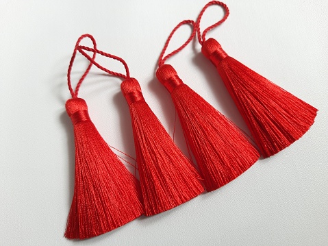 A tassel is an ornament or decoration that's made of threads. Tassels are used to decorate curtains, pillows, and clothing