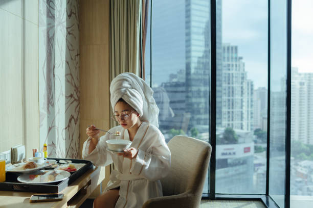 istock Lady eating breakfast in the hotel room 1338614845