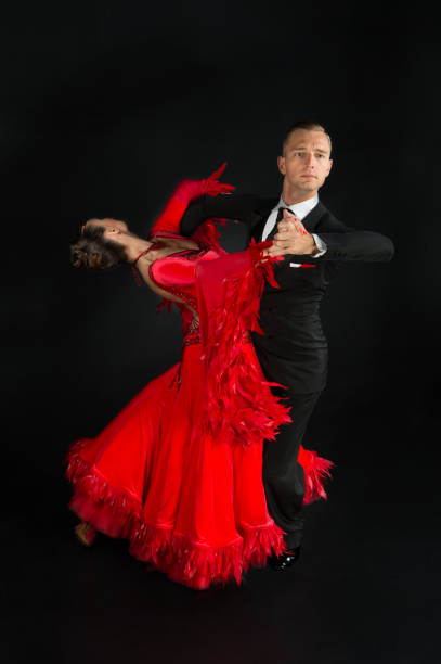 istock ballrom dance couple in a dance pose isolated on black background 1338614910
