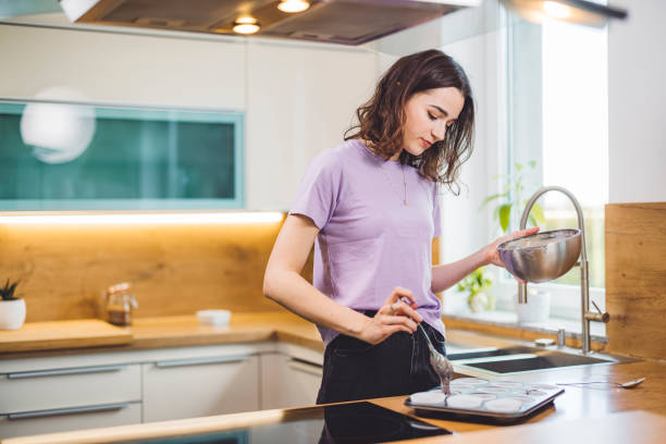 istock Caucasian woman baking muffins 1338615677